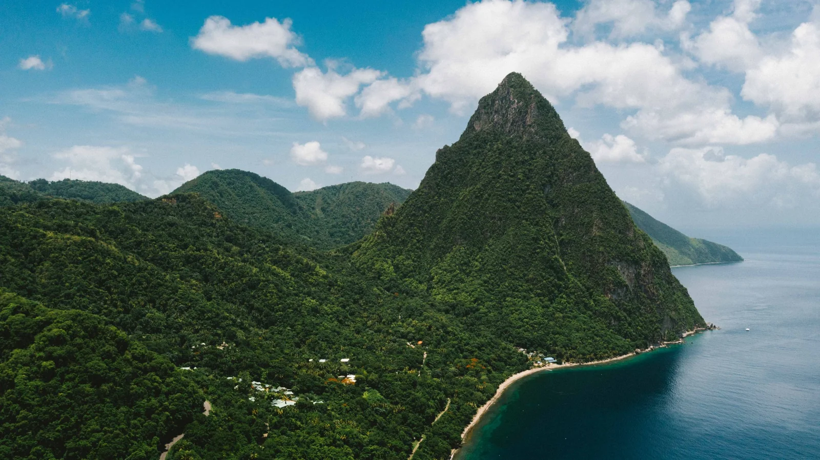 Aerial view of the lush St. Lucia coastline and a Piton
